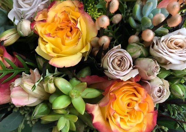 A Love N' Bloom arrangement: garden roses, succulents, and berries